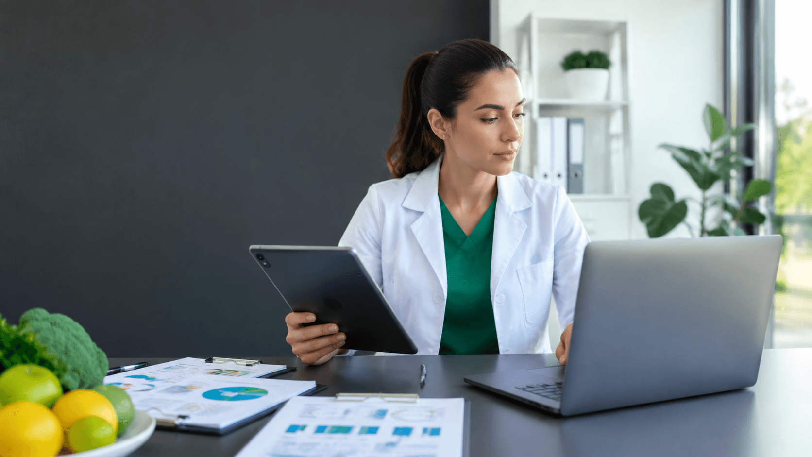 FitConnect vs Practice Better Dietitian comparing two practice software options on a laptop and a tablet